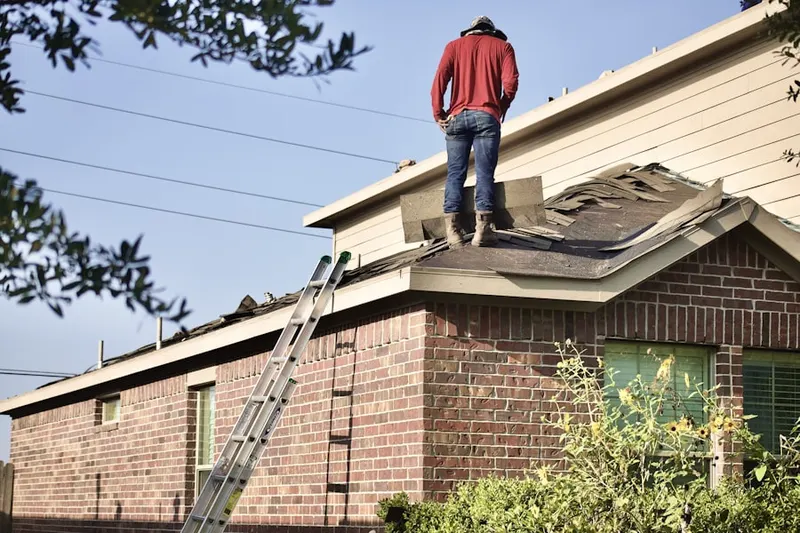 Professional roofer working on a residential roof in Central Long Beach